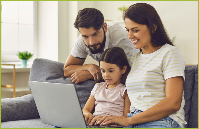 Parents with daughter viewing laptop