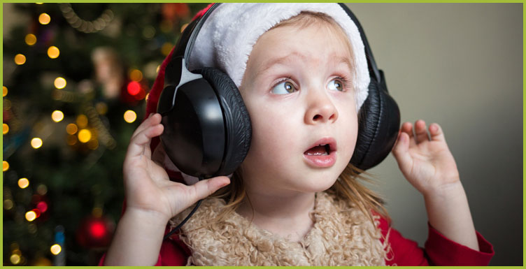 Child wearing headphones and a Santa hat