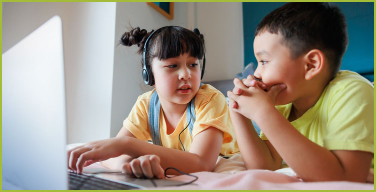 two children in front of a laptop