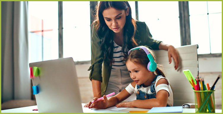 mom helping child in front of laptop